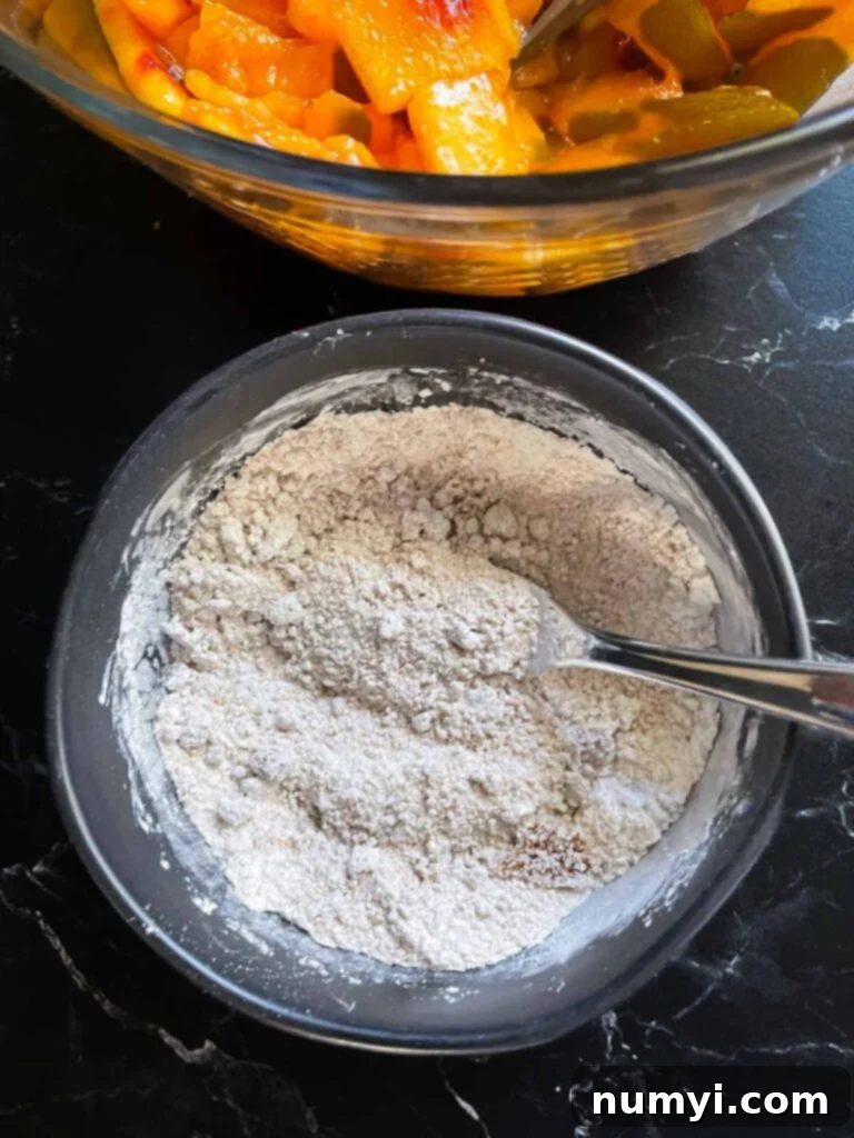 A small ramekin containing a mixture of sugars, cornstarch, and spices for the peach pie filling.