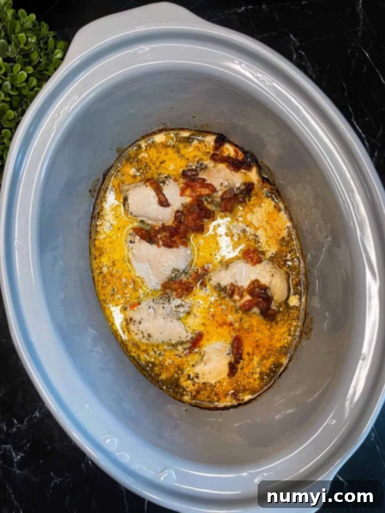 Creamy Slow Cooker Tuscan Chicken 9 Cooked Slow Cooker Tuscan Chicken in a slow cooker.