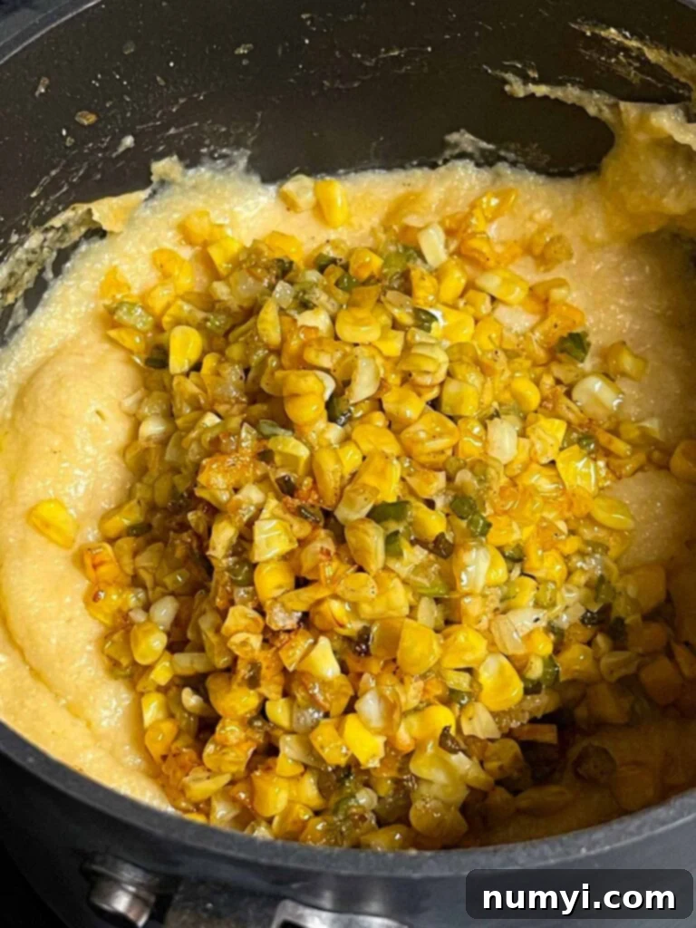 Adding a butter corn mixture to polenta.