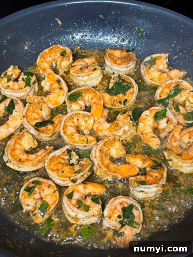 Cooked shrimp in a skillet.