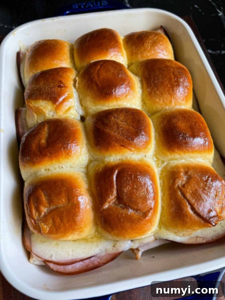 Whip Up Easy Monte Cristo Sliders for Your Next Bash 15 Cooked Monte Cristo sliders in a baking dish.