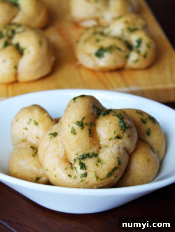 Irresistible Garlic Knots 4 A basket full of golden-brown garlic knots, ready to be served.