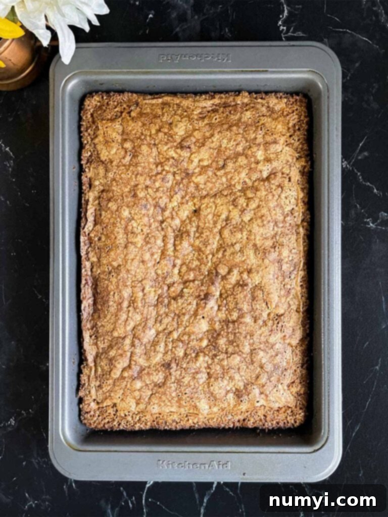 Spiced Sweet Potato Cake 10 Baked sweet potato cake in a 9x13 baking pan on a dark surface.