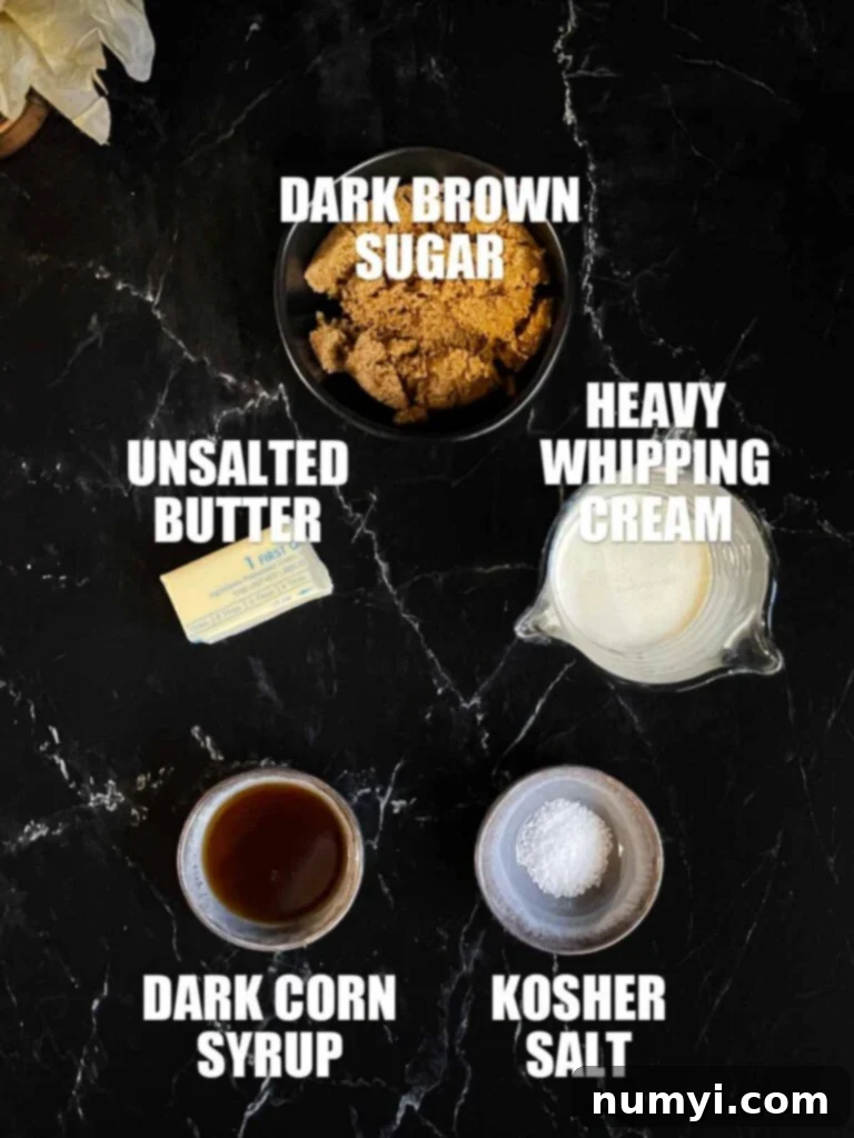 Salted Caramel Swirl Pumpkin Bread Pudding 4 Ingredients for homemade salted caramel sauce, including butter, dark brown sugar, heavy cream, corn syrup, and salt, artfully laid out on a dark surface.