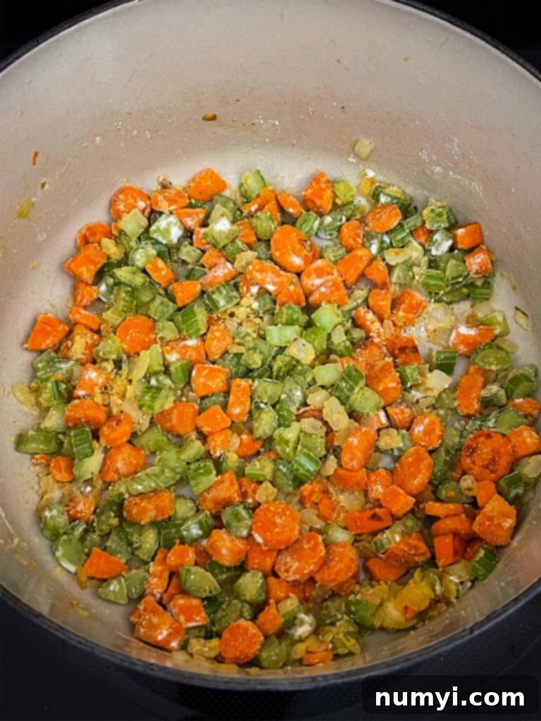 Velvety Potato Corn Chowder with Crispy Bacon 8 Flour cooking with mirepoix in a dutch oven.
