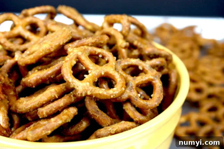 A vibrant yellow bowl filled with golden-brown honey mustard pretzels, ready to be enjoyed as a delicious snack.