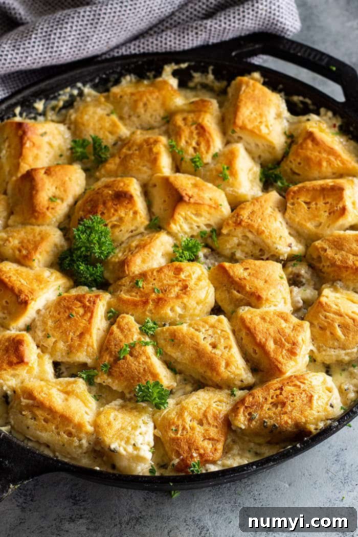 Biscuits and Gravy Casserole cooked in a skillet, showcasing the golden biscuits and creamy gravy.
