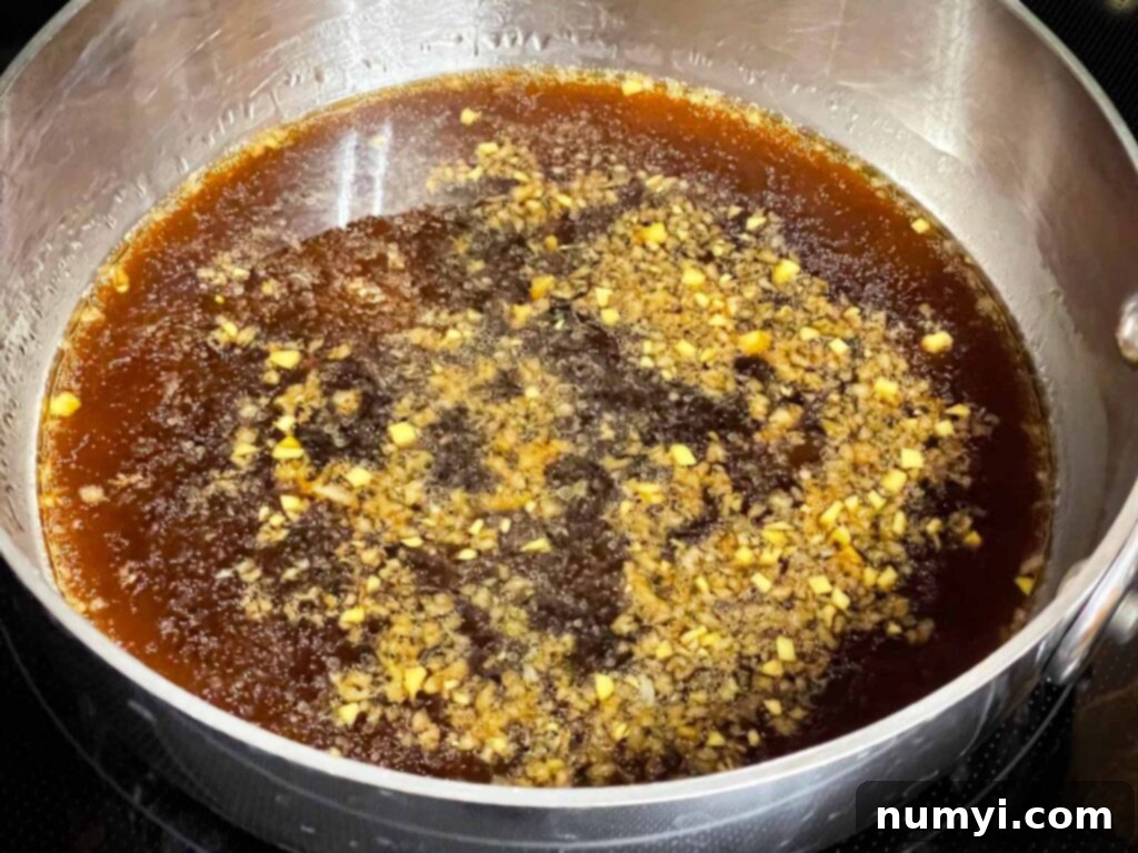 Chicken teriyaki marinade heating up in a sauce pan.