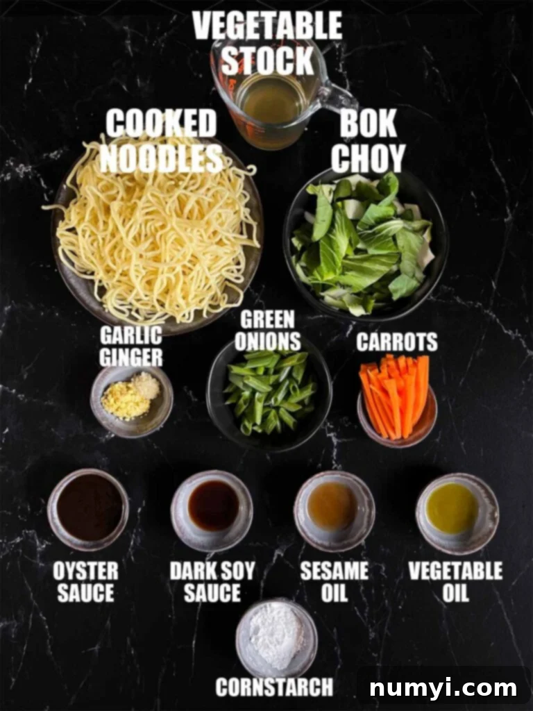 A selection of fresh Lo Mein ingredients arranged on a dark surface, including colorful bok choy, carrots, green onions, and essential sauces like soy sauce and oyster sauce, along with spices like ginger and garlic.