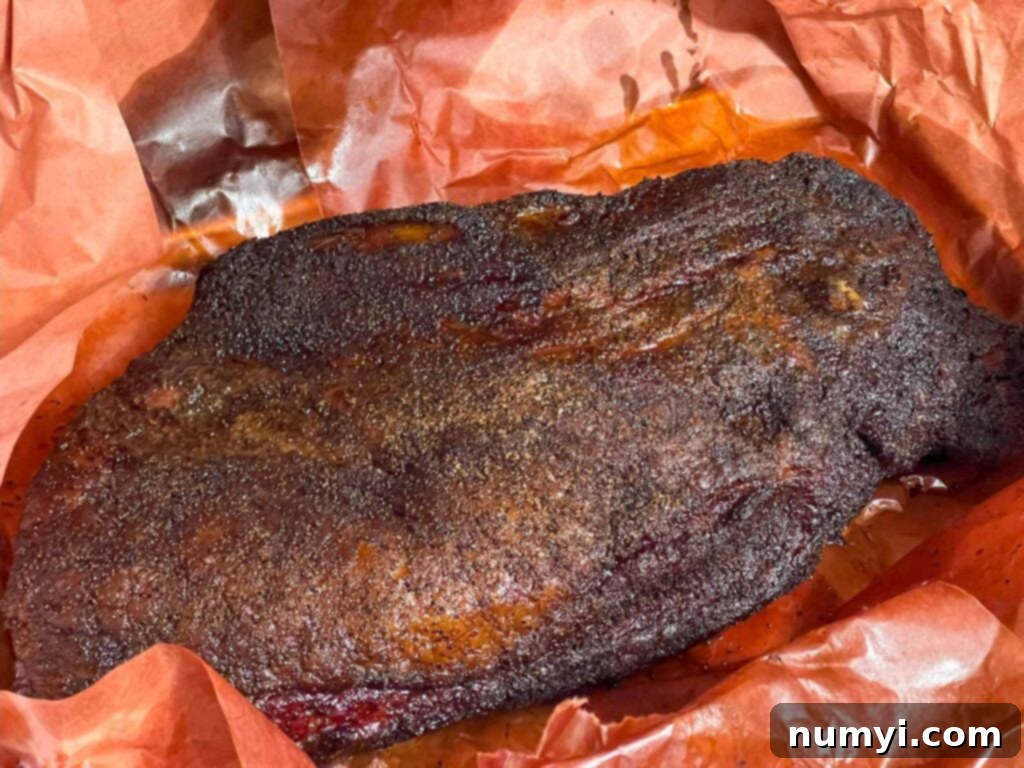 A smoked brisket with the butcher paper unwrapped.