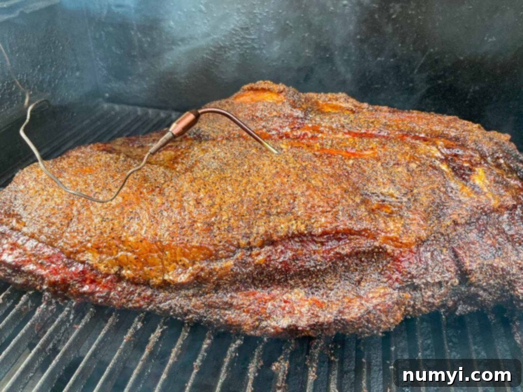 A brisket smoking in a smoker.