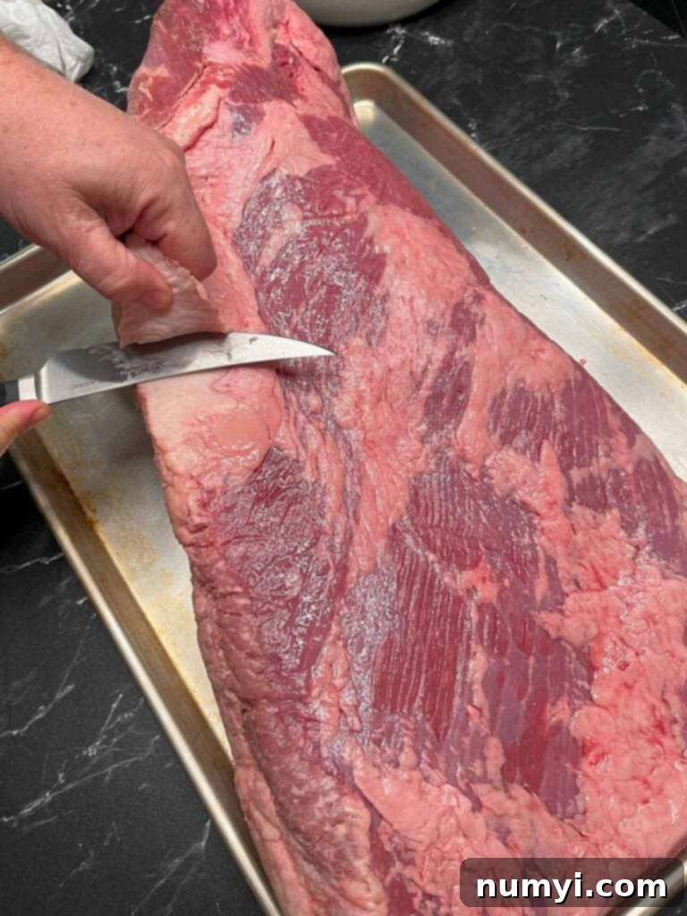 Trimming the deckle out of a brisket.