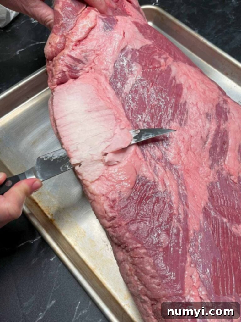 Trimming the deckle out of the brisket.
