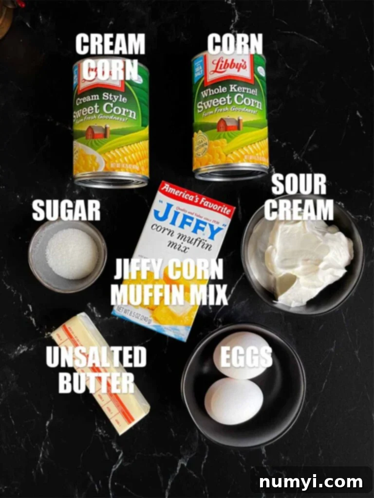 All the fresh ingredients required to make a delicious corn casserole laid out neatly on a dark kitchen counter.