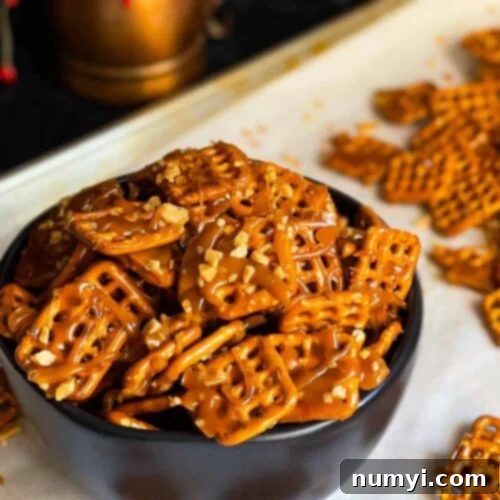 Butter toffee pretzels in a dark bowl on the baking sheet, a perfect blend of sweet and salty.