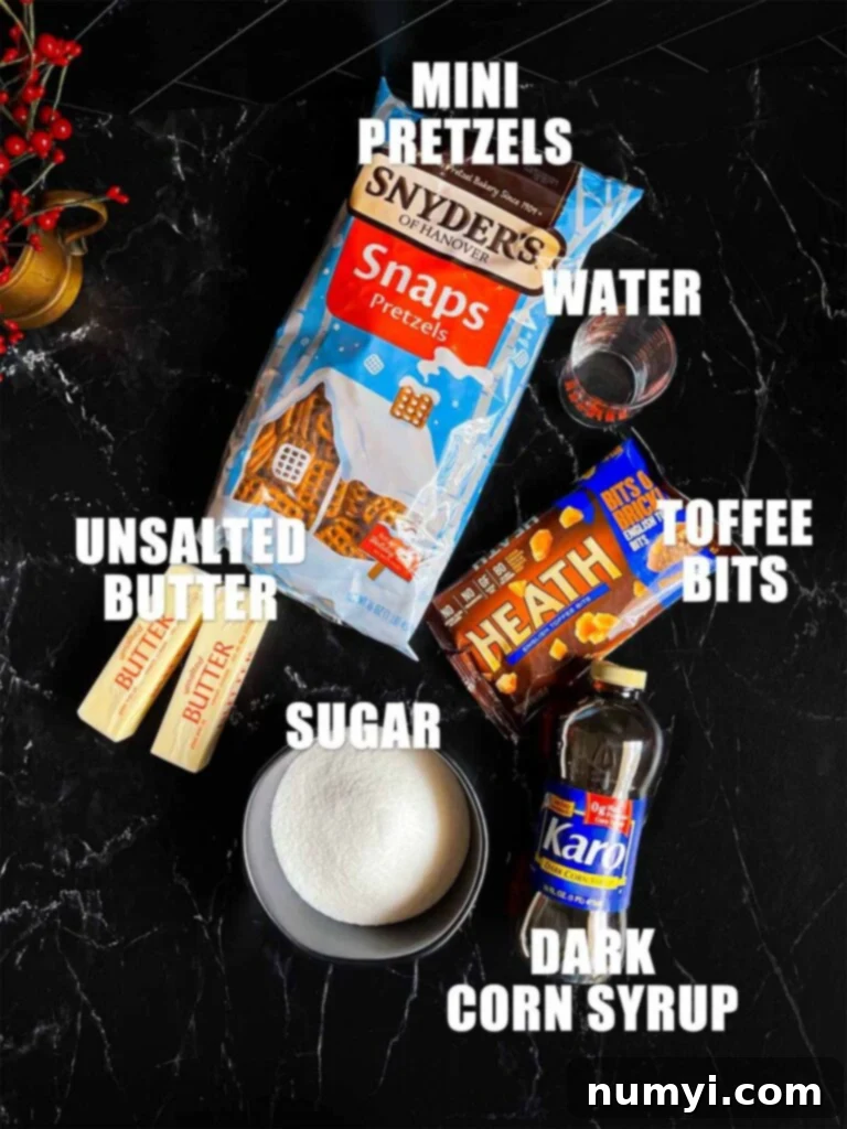 Various ingredients for toffee pretzels, including sugar, butter, corn syrup, and pretzels, laid out on a dark surface.
