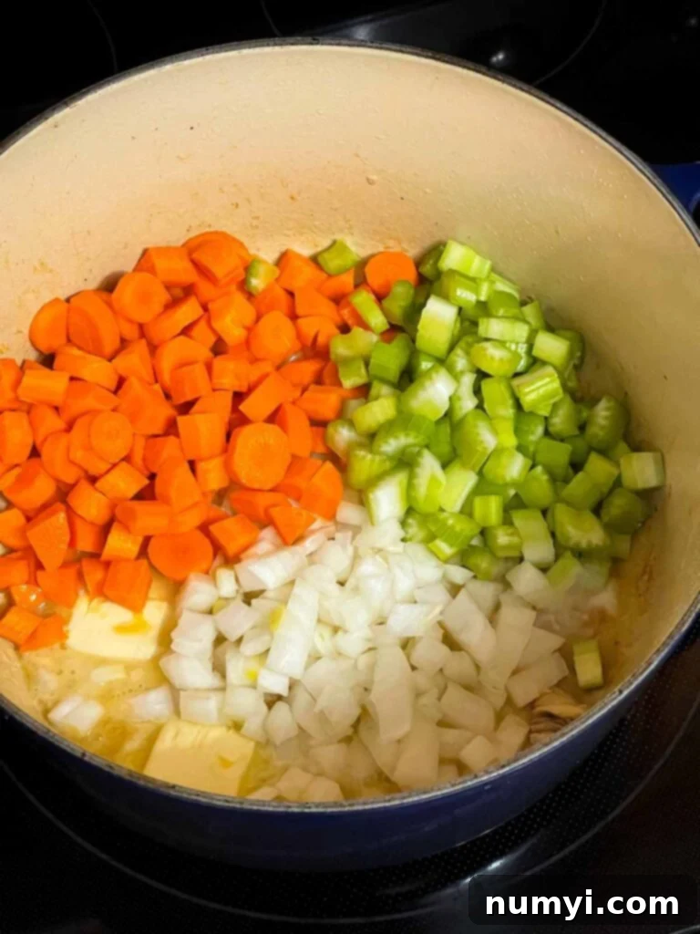 Onions, celery, and carrot in a dutch oven.