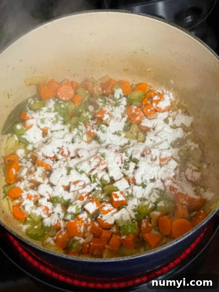 Making a roux with the cooked vegetables in a dutch oven.