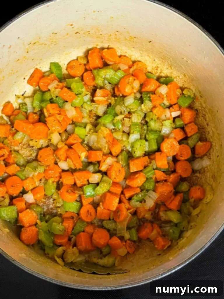Cooked vegetables in a roux in a dutch oven.