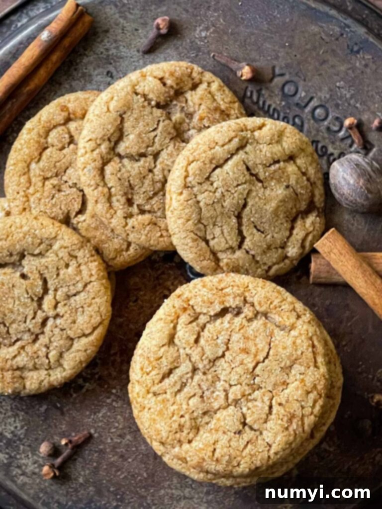 Cozy Chai Sugar Cookies 9 Freshly baked chai sugar cookies cooling on an old metal cake pan, showing their perfect shape and spiced coating.