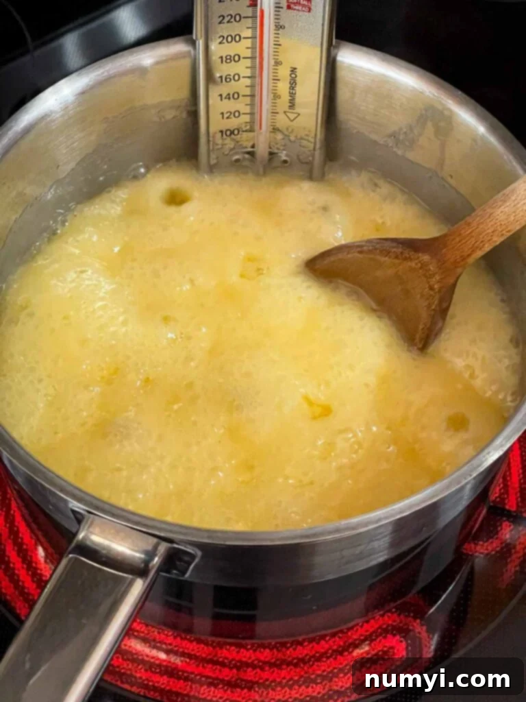 Eggnog fudge ingredients boiling in a saucepan.