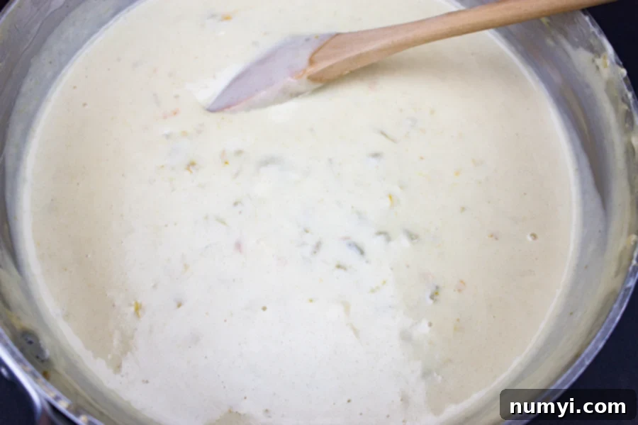 Velvety Smooth Restaurant Queso 4 Restaurant Style Queso Dip in a metal sauce pan