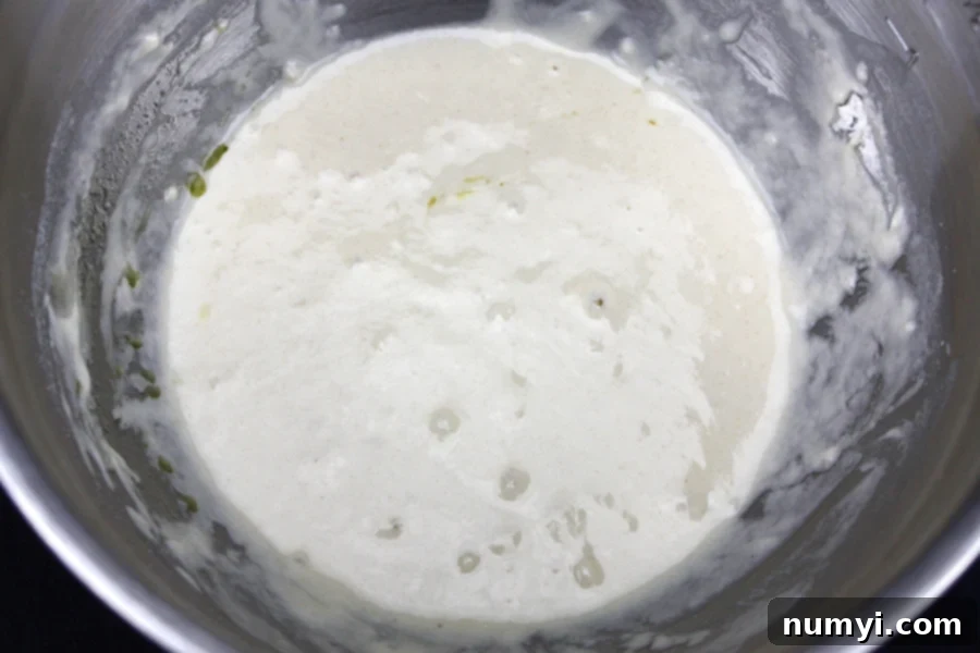 Close-up of fluffy vegetable dumpling batter in a small metal bowl, showing the perfect consistency before being added to the soup.