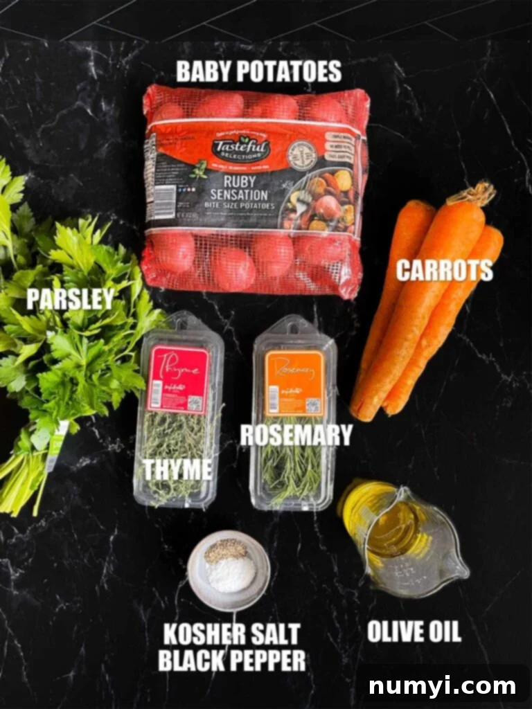 Ingredients for roasted potatoes and carrots on a dark surface.
