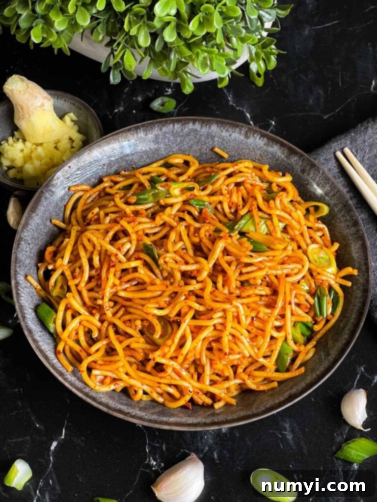 Fiery Garlic Noodle Express 11 Close-up of spicy garlic noodles in a dark bowl, ready to be served.