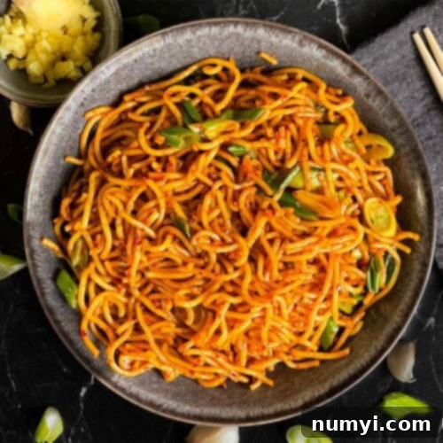 Fiery Garlic Noodle Express 13 Spicy garlic noodles in a dark bowl.