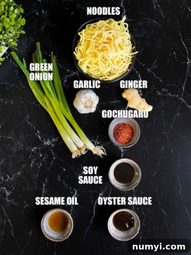 Fiery Garlic Noodle Express 3 Various ingredients for spicy garlic noodles laid out, including garlic, ginger, gochugaru, green onions, and noodles.