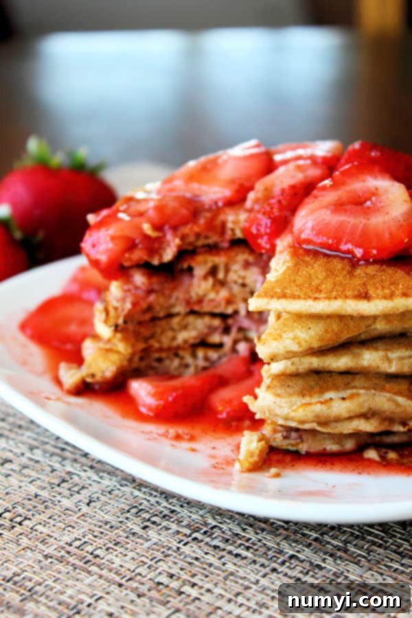 Wholesome Strawberry Pancake Delight 2 Whole Wheat Strawberry Pancakes with strawberry syrup on top