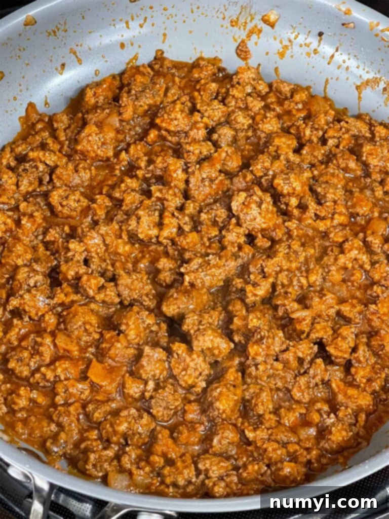 A sloppy joe mixture cooking in a skillet.