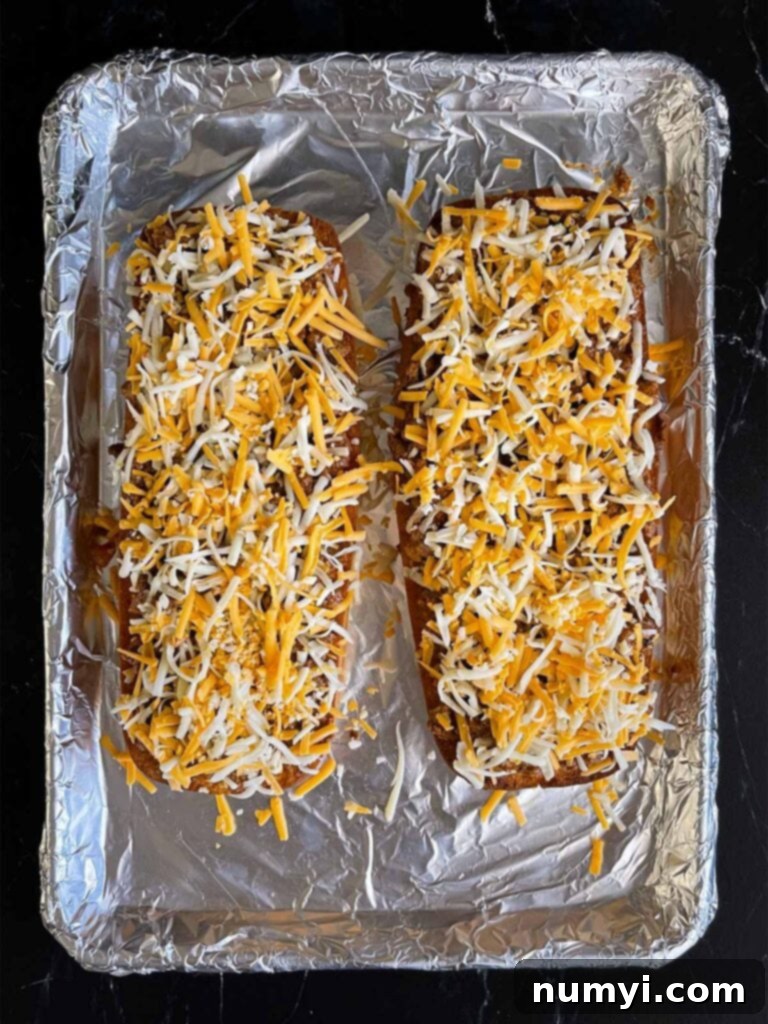 Cheese on top of french bread sloppy joes.