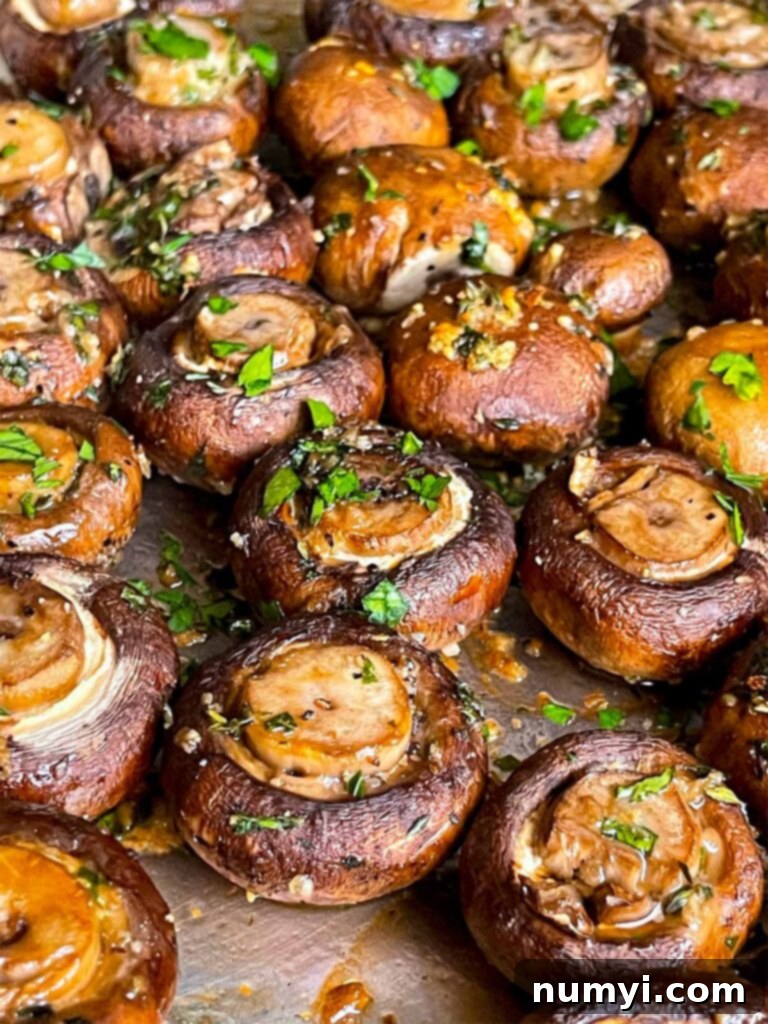 Garlic butter roasted mushrooms on a baking sheet, freshly out of the oven and perfectly browned.