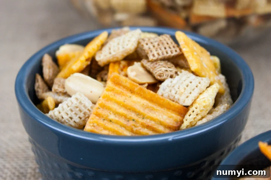 Spicy Cheddar Snack Mix in a blue serving bowl.