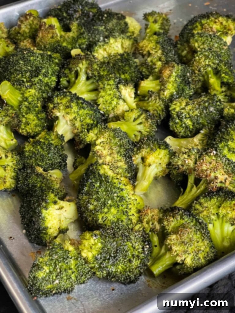 Crispy Oven Roasted Broccoli 6 Roasted broccoli on a baking sheet.