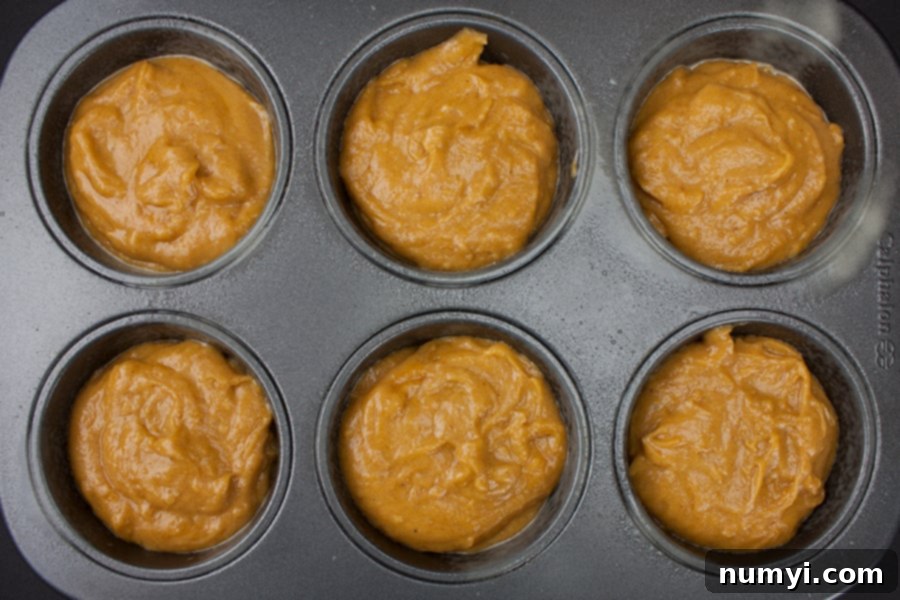 Ultimate Pumpkin Muffins 5 Bakery Style Pumpkin Muffins batter divided into a jumbo muffin tin, filled generously for a perfect dome.