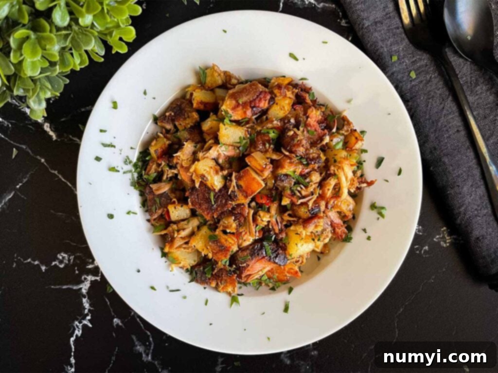 Hearty Smoked Pulled Pork Hash 2 Smoked pulled pork hash garnished with parsley in a white bowl.
