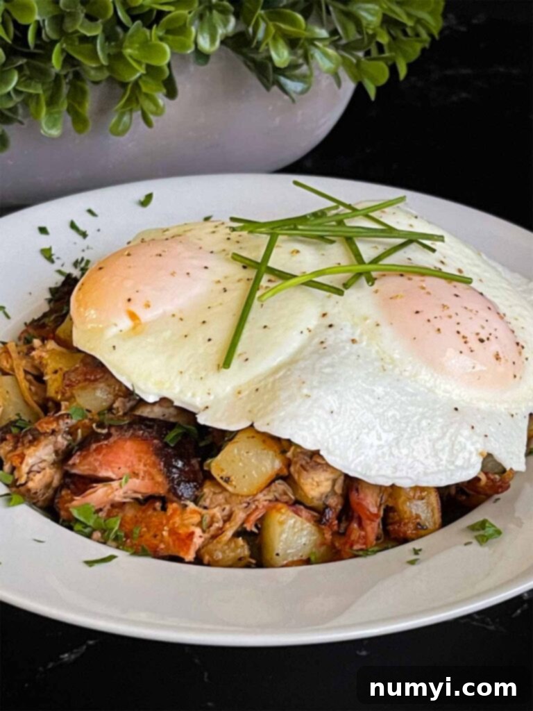 Hearty Smoked Pulled Pork Hash 11 Smoked pulled pork hash garnished with parsley in a white bowl.