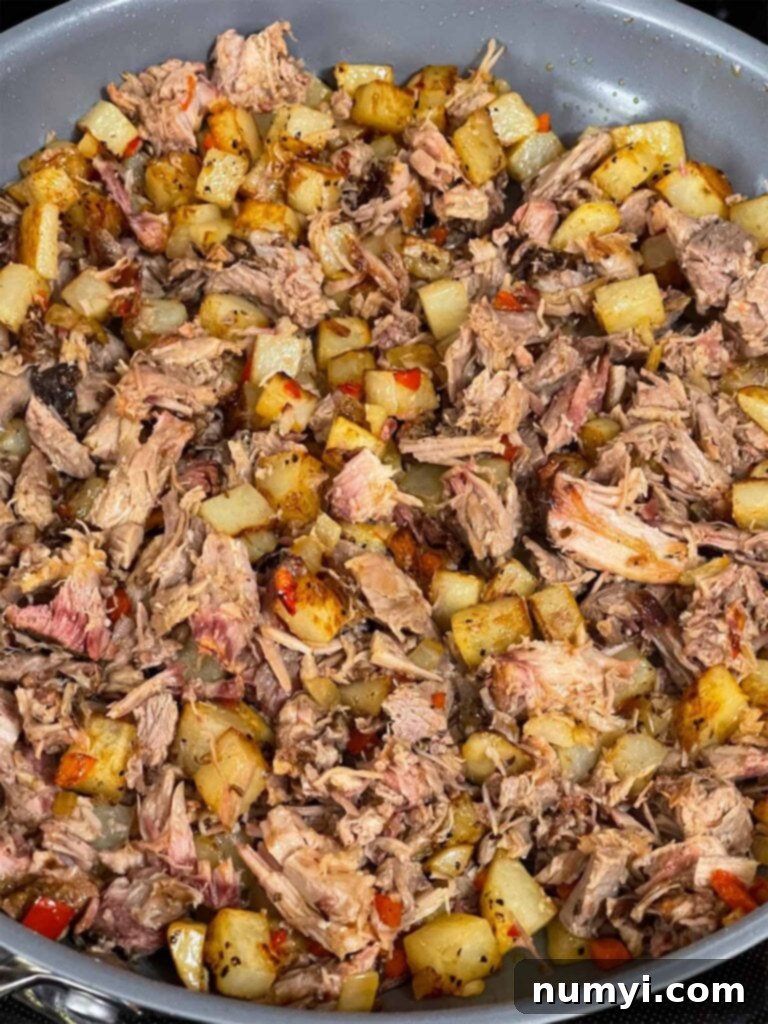 Hearty Smoked Pulled Pork Hash 8 Pulled pork hash cooking in a skillet.
