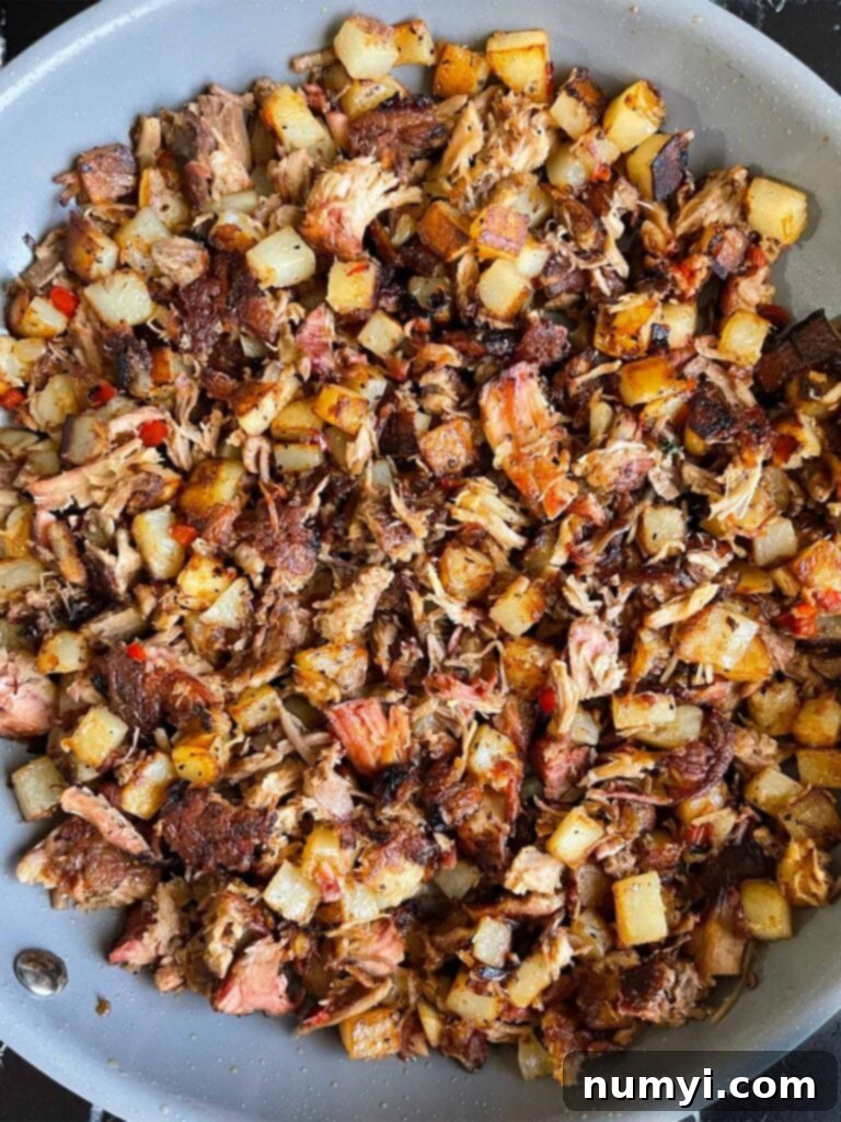 Hearty Smoked Pulled Pork Hash 9 Cooked pulled pork hash in a skillet.