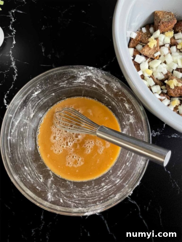 Beef broth and Worcestershire sauce whisked together with the remaining flour in a glass bowl.