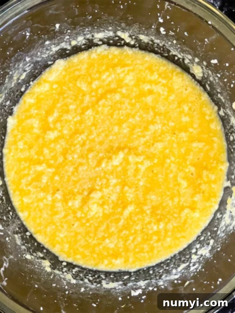 Sunshine Lemon Streusel 8 Lemon crumb cake wet ingredients mixed together in a glass mixing bowl.