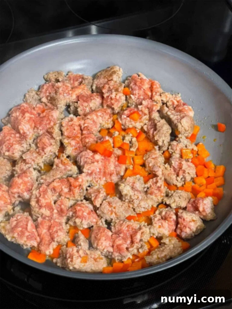 Cheesy Sausage Grits Bake 4 Ground sausage and red bell pepper in a skillet.