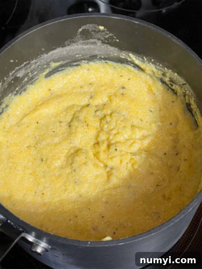 Cheesy Sausage Grits Bake 9 Cooked grits in a saucepan.