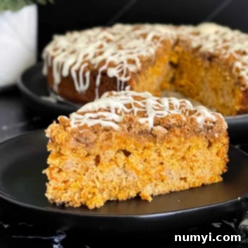 A delectable slice of carrot coffee cake on a dark plate, showing off its moist interior and tempting toppings.