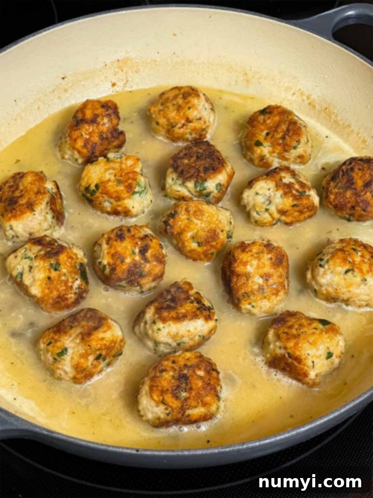 Chicken Piccata Meatballs in a skillet.