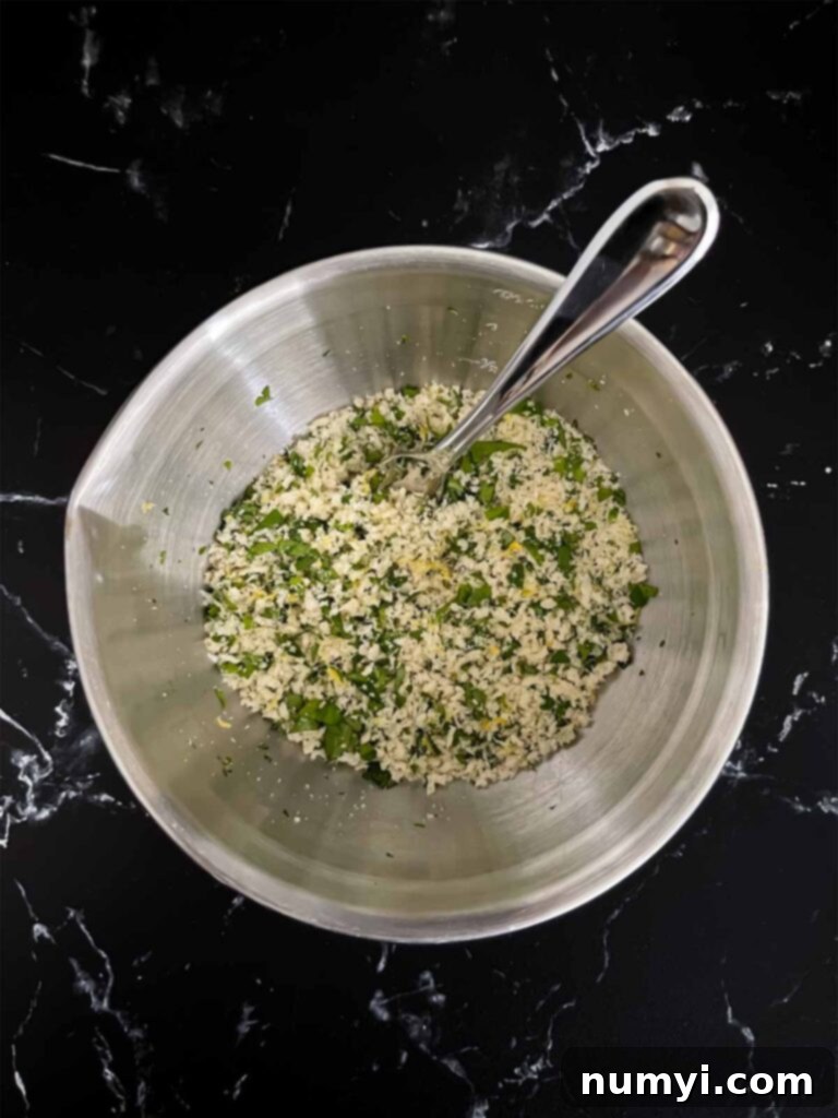 A bowl containing chicken piccata meatball mixture.