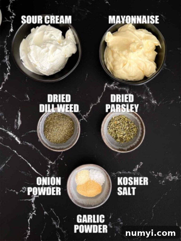 Dill dip recipe ingredients on a dark surface.